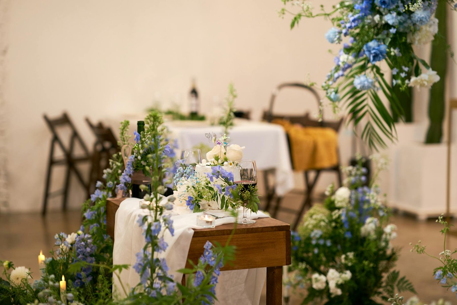 Luxurious wedding setup featuring blue and white flowers on a beautifully decorated table.