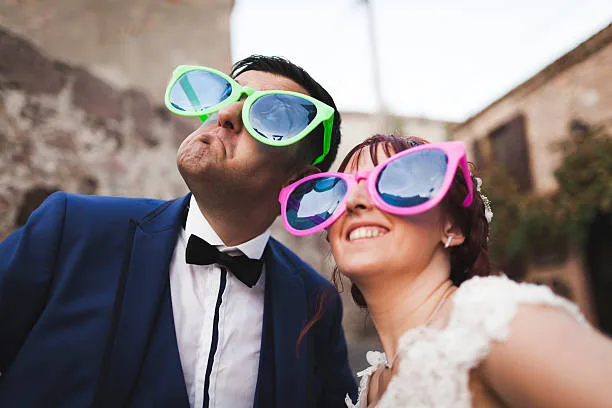 bride and groom with large sunglasses at their outdoor wedding
