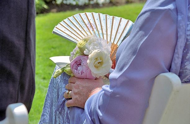 Provide fans at your outdoor wedding Fan at a garden wedding