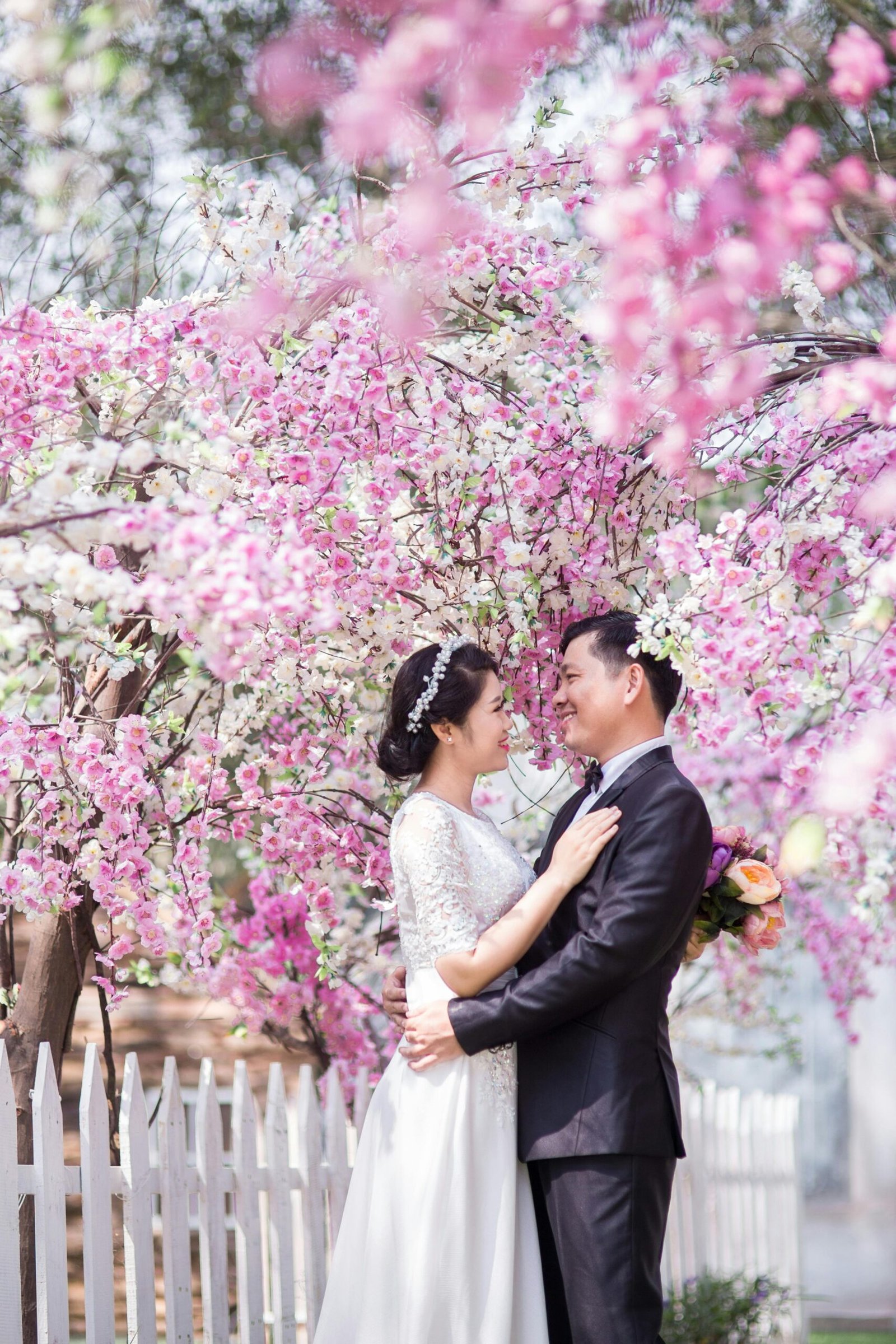 Bride and groom surrounded by flowers