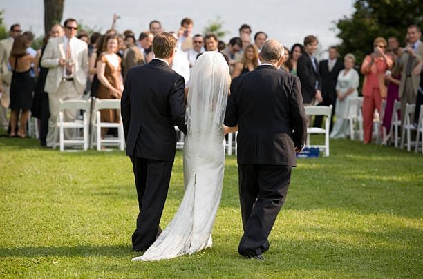 Bride escorted by 2 dads
