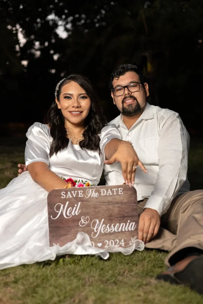 The Ultimate Guide to Wedding Planning. Couple with Save the Date sign
