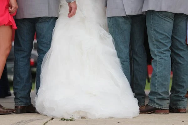 wedding party wearing jeans with the bride in her wedding dress