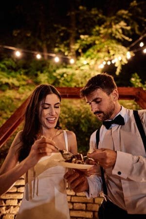 Bride and groom enjoy a late night snack. Wedding planning hack