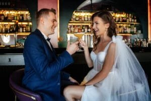 Wedding bar drink menu. Brid and groom enjoy a drink at their wedding