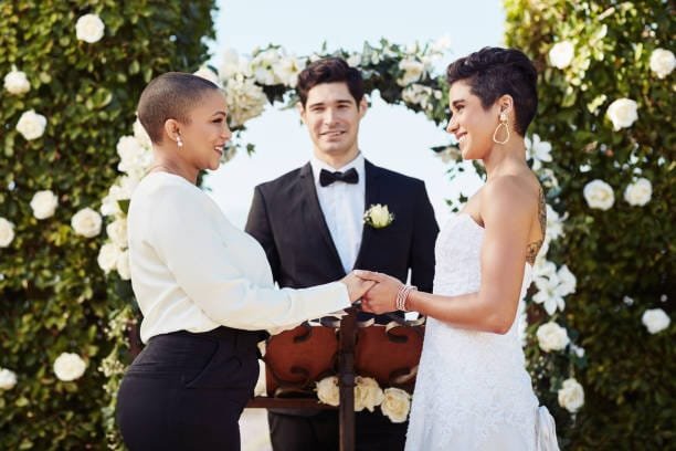 Modern wedding traditions. Two bride exchange vows