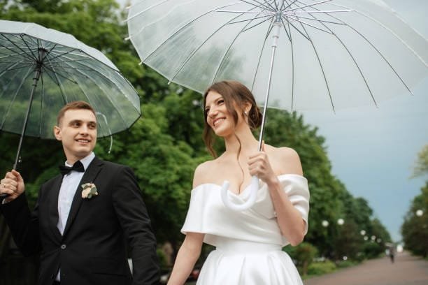 bride and groom get married in the rain