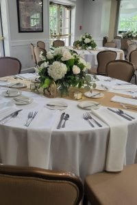 DIY floral arrangement. Wedding reception dinner table.